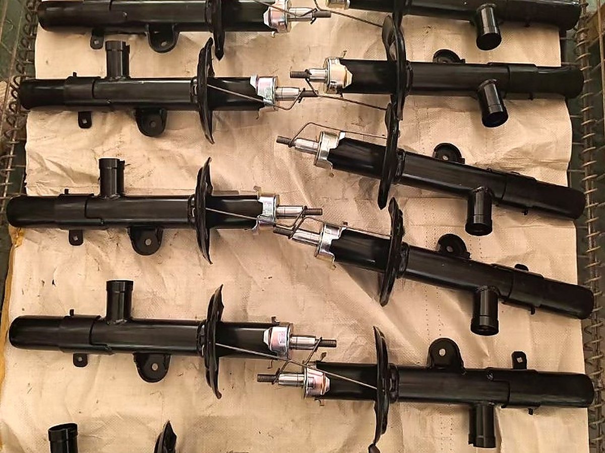 Shock absorber struts wrapped and stacked in cartons ready for container loading